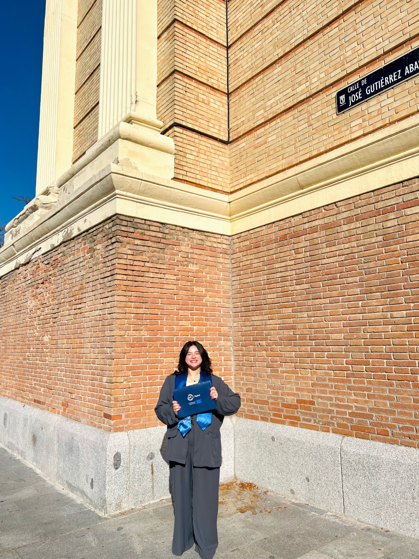 Sanya holding her degree in Madrid